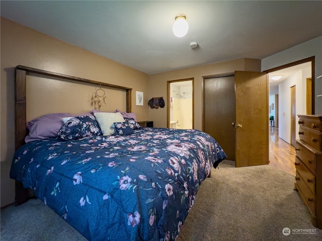 carpeted bedroom featuring ensuite bathroom