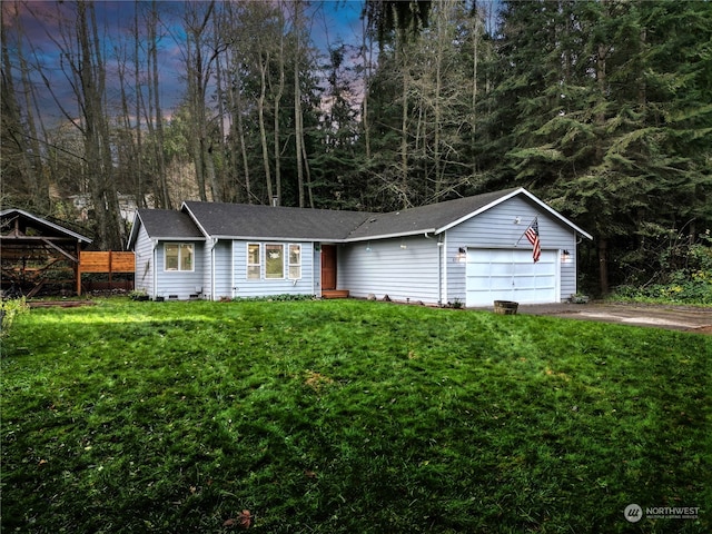 ranch-style home featuring a garage, a yard, and a carport