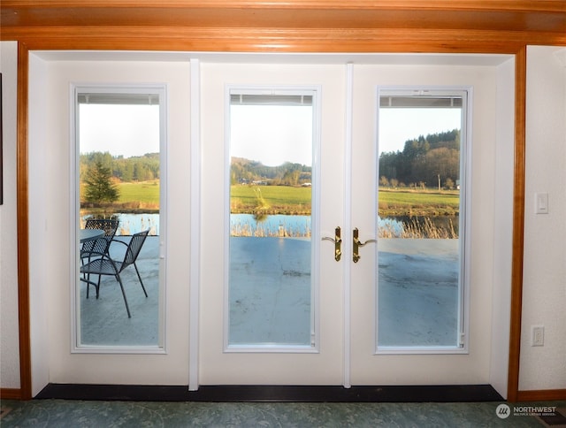 entryway featuring french doors and a water view