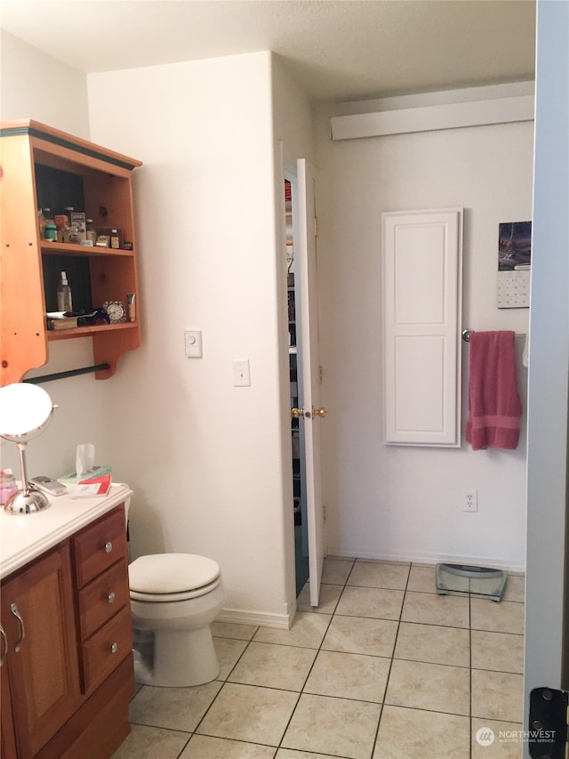 bathroom featuring tile patterned flooring, vanity, and toilet