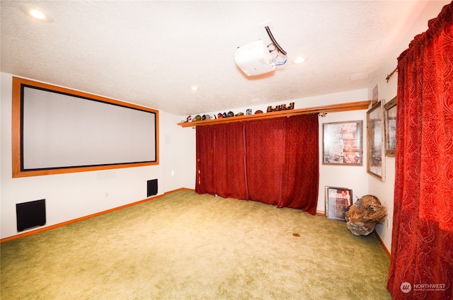 cinema with carpet flooring and a textured ceiling