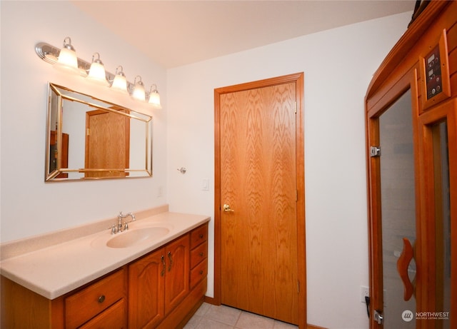 bathroom featuring tile patterned flooring and vanity