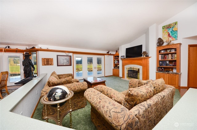 carpeted living room featuring a tiled fireplace, a healthy amount of sunlight, and lofted ceiling