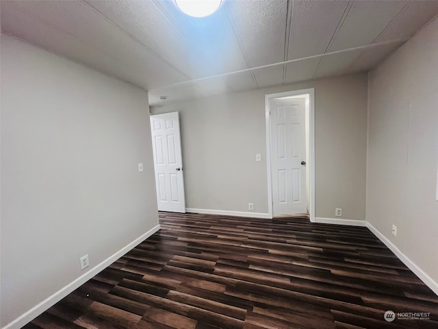 spare room featuring dark hardwood / wood-style flooring