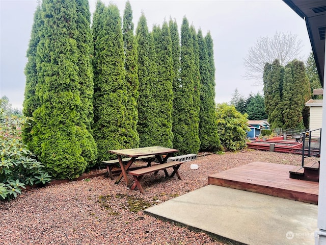 view of yard with a deck and a patio