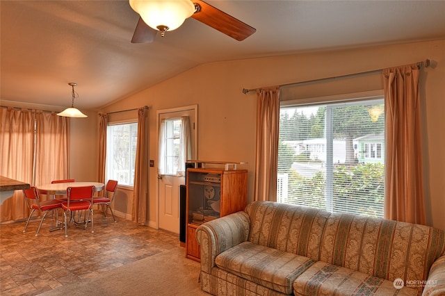 living room with ceiling fan and vaulted ceiling