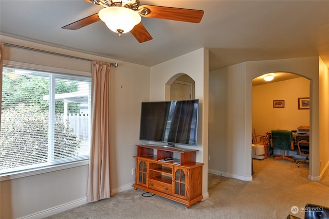 carpeted living room with ceiling fan