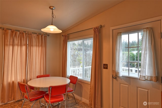 dining space with vaulted ceiling and a wealth of natural light