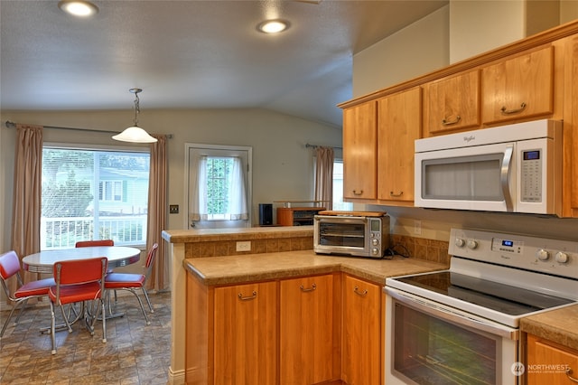 kitchen with kitchen peninsula, stainless steel range with electric cooktop, pendant lighting, and vaulted ceiling