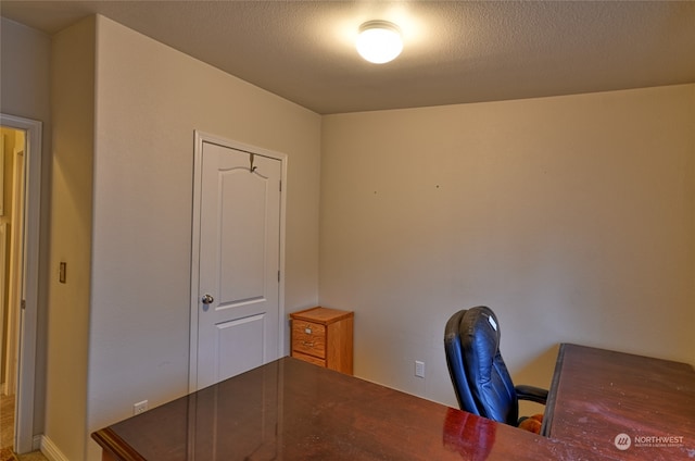 unfurnished office with a textured ceiling