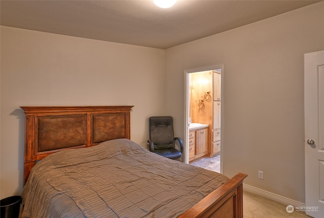 carpeted bedroom featuring ensuite bathroom