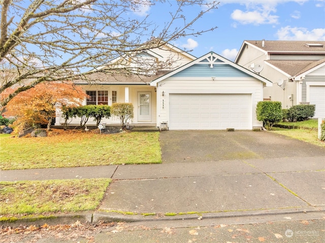 view of front of property featuring a front yard and a garage