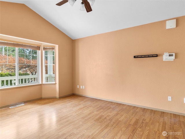 spare room featuring light hardwood / wood-style floors, ceiling fan, and lofted ceiling