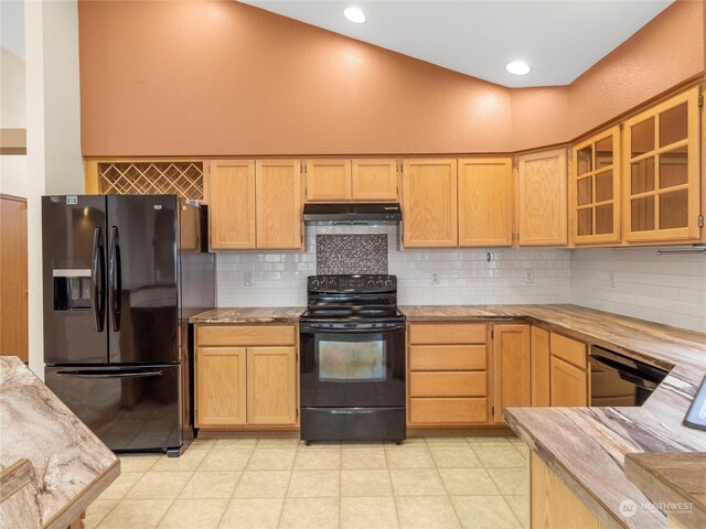 kitchen featuring decorative backsplash, light brown cabinets, and black appliances