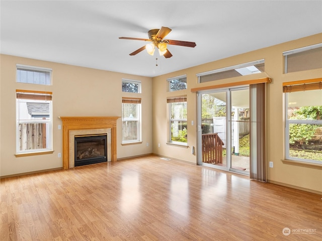 unfurnished living room featuring light wood-type flooring and ceiling fan