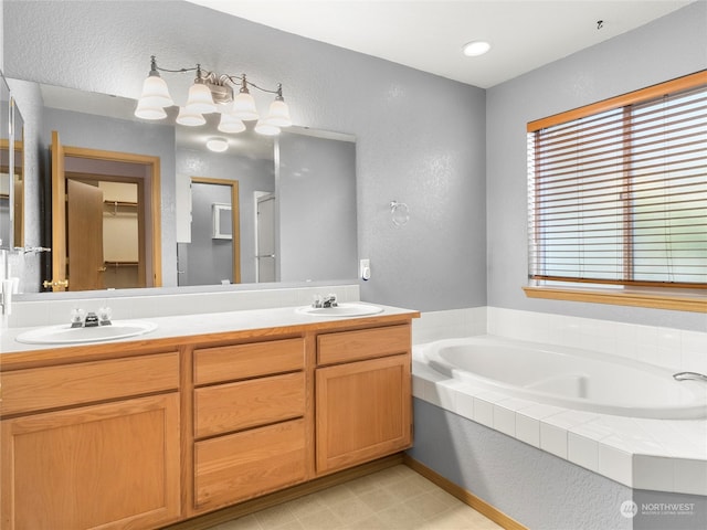 bathroom with vanity and a tub