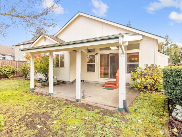 rear view of house featuring a patio area and a lawn