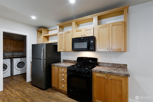 kitchen with black appliances, washer and dryer, dark hardwood / wood-style floors, and light brown cabinets