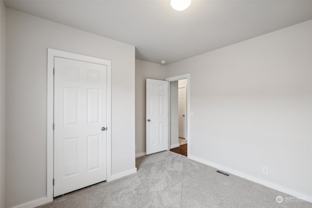 unfurnished bedroom with light colored carpet