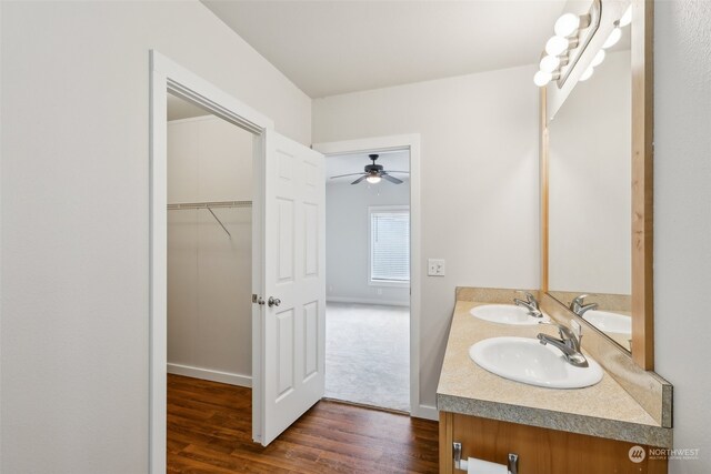 bathroom featuring hardwood / wood-style flooring, vanity, and ceiling fan