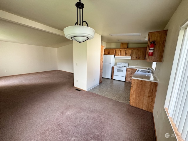 kitchen with sink, decorative light fixtures, white appliances, and dark colored carpet