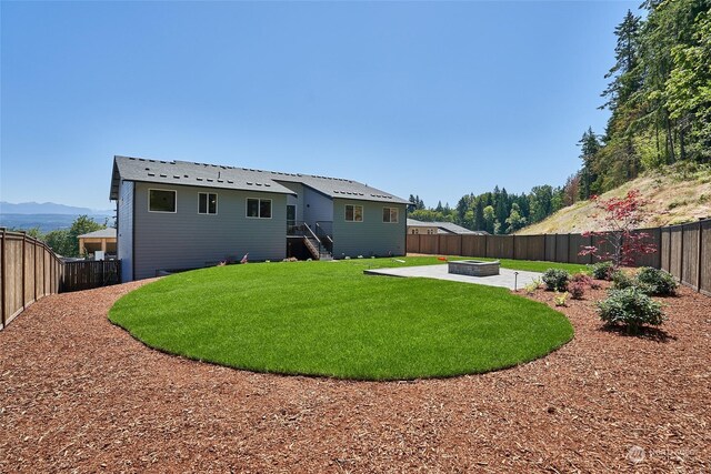 17726 142nd Ave E Unit 9, Puyallup, WA 98374 - back of house featuring a fire pit and a patio