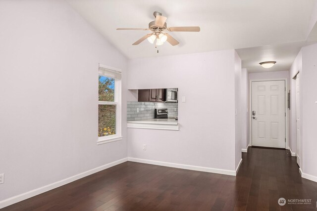 empty room with ceiling fan, dark wood-type flooring, and vaulted ceiling