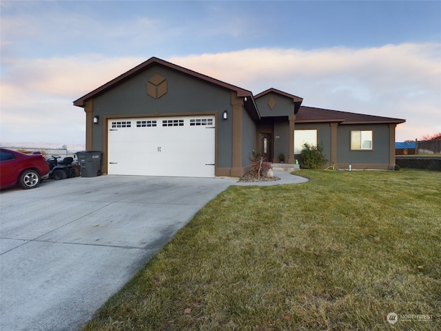 view of front of home with a yard and a garage