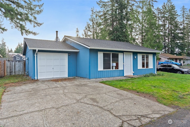 ranch-style home with a garage and a front lawn