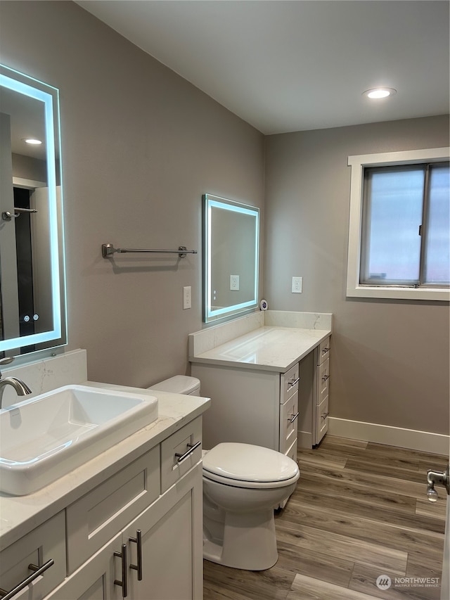 bathroom featuring vanity, toilet, and wood-type flooring