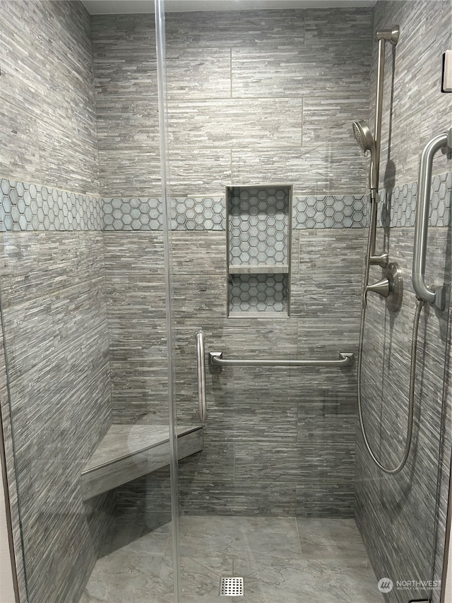 bathroom with a shower with shower door