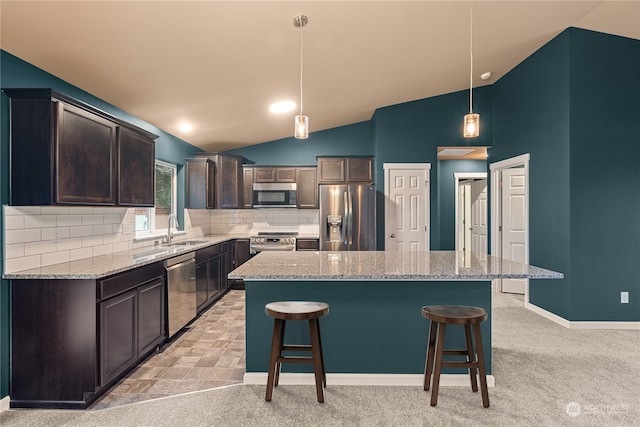 394 Lake View Loop NE, Ocean Shores, WA 98569 - kitchen with appliances with stainless steel finishes, a sink, dark brown cabinetry, lofted ceiling, and a breakfast bar