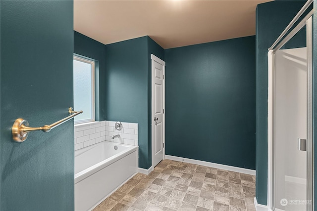 394 Lake View Loop NE, Ocean Shores, WA 98569 - bathroom with a bath, baseboards, and stone finish flooring