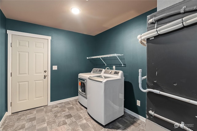 394 Lake View Loop NE, Ocean Shores, WA 98569 - washroom with washing machine and clothes dryer, baseboards, and stone finish floors