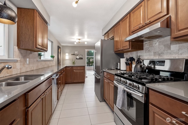 kitchen featuring light tile patterned floors, stainless steel appliances, tasteful backsplash, and sink