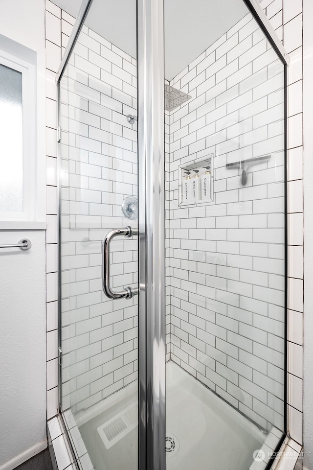 bathroom with a shower with shower door