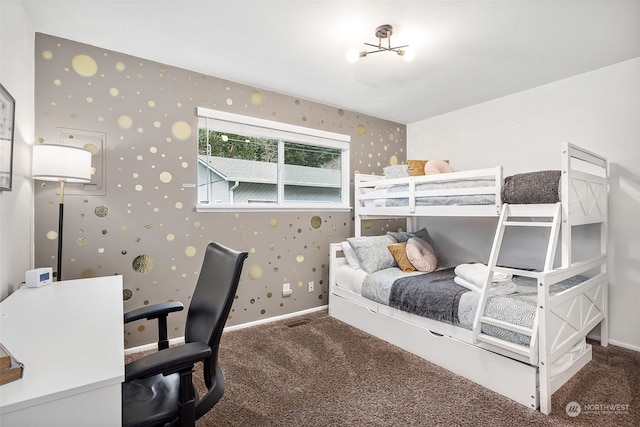 bedroom with dark carpet and a chandelier