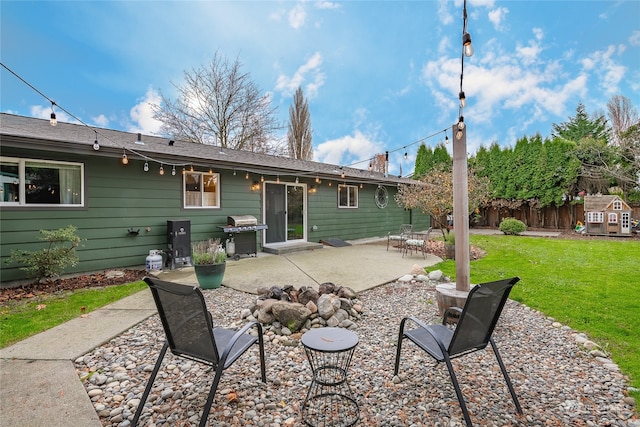 back of house with a yard and a patio