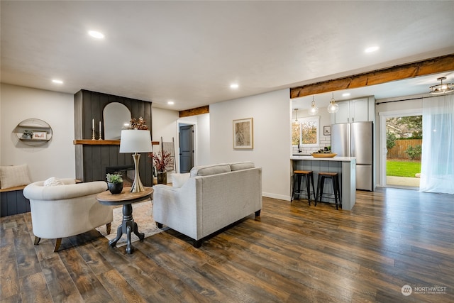 living room featuring a fireplace and dark wood-type flooring