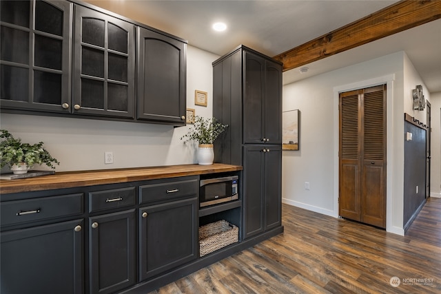 kitchen with dark hardwood / wood-style floors and wood counters