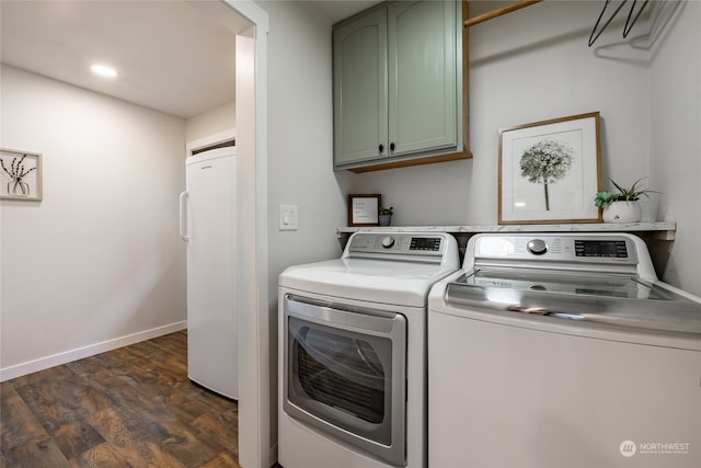 laundry area featuring cabinets, independent washer and dryer, and dark wood-type flooring