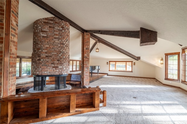 interior space with beam ceiling, carpet floors, a textured ceiling, and high vaulted ceiling