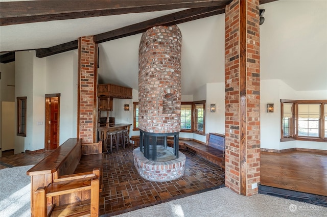 dining area featuring beamed ceiling, ornate columns, carpet floors, and high vaulted ceiling