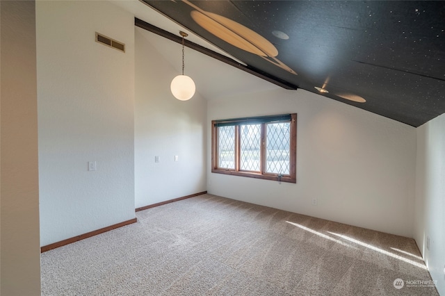 spare room featuring lofted ceiling and carpet floors