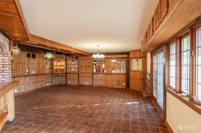 interior space with wood walls and an inviting chandelier