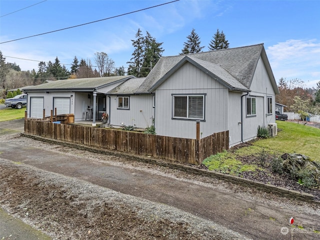 view of front of house featuring central AC unit and a garage