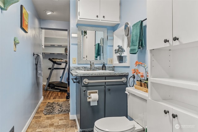 bathroom featuring hardwood / wood-style flooring, vanity, and toilet