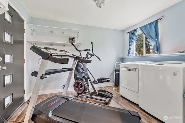 workout room featuring light wood-type flooring and washing machine and dryer