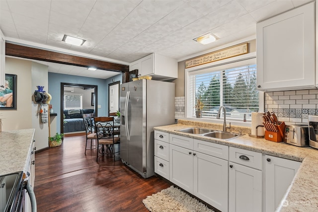 kitchen featuring appliances with stainless steel finishes, tasteful backsplash, sink, dark hardwood / wood-style floors, and white cabinetry