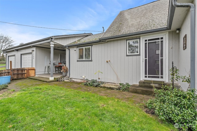 rear view of property featuring a lawn